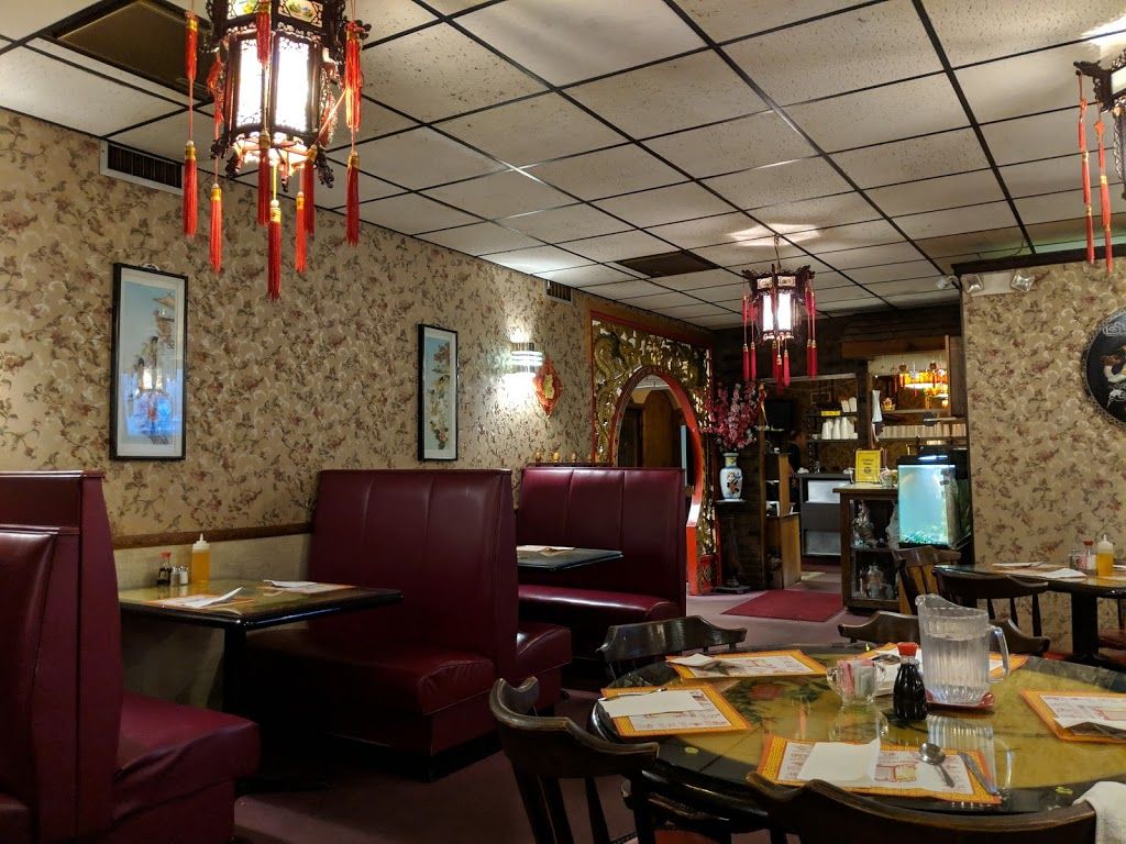 Booths and the moon-gate archway inside The Golden Moon on Miller Rd