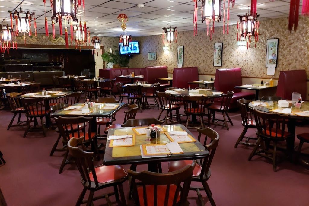 The Golden Moon dining room with lanterns and round family-style tables